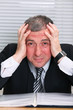 Business man with a head ache and red face Business man with a head ache and red face