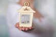 Woman holding a cosy house in her hands