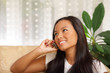 Photo: Happy woman on phone lying on a sofa in the living-room Happy woman on phone lying on a sofa in the living-room