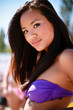 Photo: Closeup portrait of a young asian model in swimwear on the beach Closeup portrait of a young asian model in swimwear on the beach