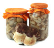 Banks with marinaded mushrooms on a white background