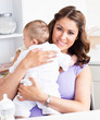 Caucasian young mother taking care of her adorable baby