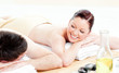 Caucasian young couple receiving a back massage Caucasian young couple receiving a back massage