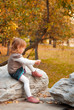Girl (3 years old) tying shoelace #2 in park