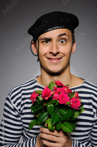 Photo: Funny emotional romantic sailor man holding rose flowers prepare Funny emotional romantic sailor man holding rose flowers prepare