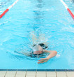 young woman swim on indoor pool. freestyle mode.
