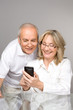 Happy senior people with a phone