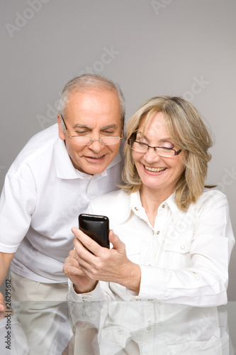 Photo: Happy senior people with a phone Happy senior people with a phone