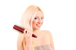 Beautiful young blonde woman brushing her long hair Beautiful young blonde woman brushing her long hair