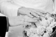 Photo: Bride and groom showing wedding ring and bouquet Bride and groom showing wedding ring and bouquet