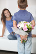 Little boy giving flowers to his mom on mother's day