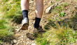 Man runs along a mountain path, closeup feet, sneakers Man runs along a mountain path, closeup feet, sneakers
