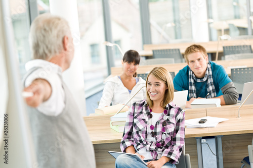 Photo: High school - three students with mature professor High school - three students with mature professor