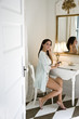 Photo: Young Hispanic woman putting on makeup Young Hispanic woman putting on makeup