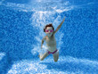 Underwater child after jumping to the swimming pool