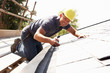 Roofer Working On Exterior Of New Home