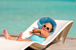 cute little girl relaxing in tropic ocean background