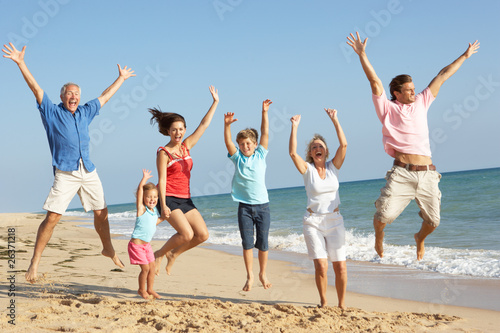 Photo : Portrait Of Three Generation Family On Beach Holiday Jumping In Portrait Of Three Generation Family On Beach Holiday Jumping In