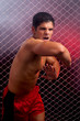 Mixed martial artist posed in front of chain link Mixed martial artist posed in front of chain link