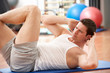 Man Doing Stretching Exercises In Gym
