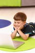 Photo : Little boy using computer at home