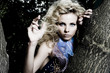 Foto: Beautiful young sexy woman on a tree Beautiful young sexy woman on a tree