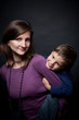mother holding his son a piggyback ride