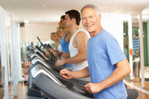 Photo: Senior Man On Running Machine In Gym Senior Man On Running Machine In Gym