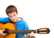 caucasian boy learning to play acoustic guita