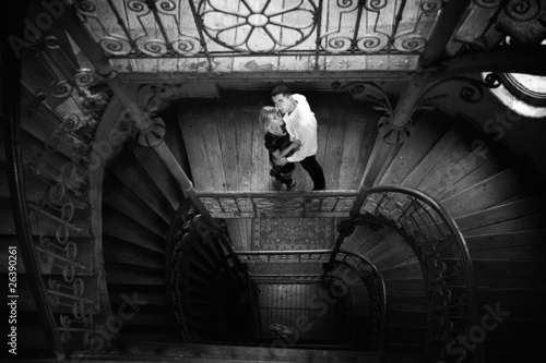 Photo: Amorous young couple hugging in old building Amorous young couple hugging in old building