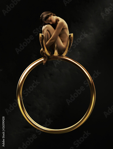Photo: Beautiful young beauty in a golden ring Beautiful young beauty in a golden ring
