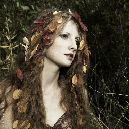 Photo: Portrait of the beautiful woman in wood Portrait of the beautiful woman in wood