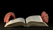 Hands and book over dark background Hands and book over dark background