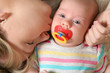 mother kissing her little baby