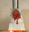 Meat grinder in action. Raw beef