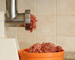 Meat grinder in action. Raw beef