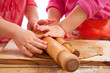 two little girls with rolling pins baking and having fun two little girls with rolling pins baking and having fun