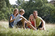 A family sitting together on the grass