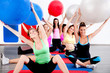 people doing stretching exercise with fitness balls