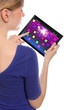 woman holding a touchpad pc and playing a retro arcade game