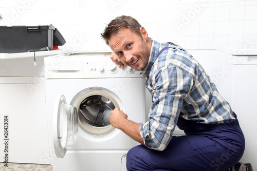 Photo: Plumber fixing broken washing machine Plumber fixing broken washing machine