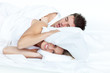 upset woman in bed with her boyfriend snoring