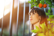 Photo: Beautiful young woman portrait in orange tree garden Beautiful young woman portrait in orange tree garden