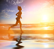 Photo: Woman running by the ocean at sunset Woman running by the ocean at sunset