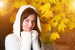 Beautiful young woman in yellow autumn park