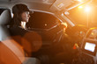 Beautiful young woman driving car at night