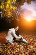 Beautiful young woman in autumn park at sunset Beautiful young woman in autumn park at sunset