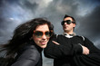 Photo: Cool young couple over dramatic cloudy sky Cool young couple over dramatic cloudy sky
