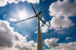 Windmill against a blue sky and clouds, alternative energy sourc Windmill against a blue sky and clouds, alternative energy sourc