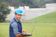 Engineer standing in front of dam under construction Engineer standing in front of dam under construction